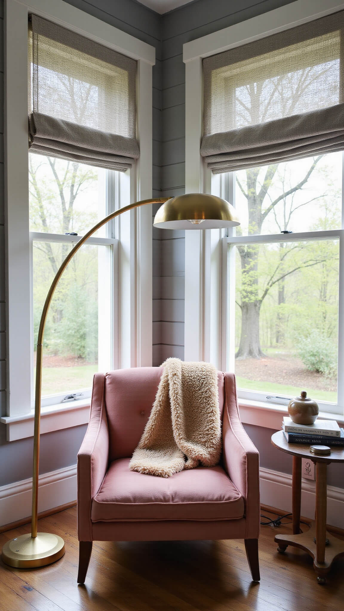 Dusty rose velvet armchair in cozy guest room reading nook with layered curtains, brass floor lamp, ceramic side table, and mohair throw in morning light.