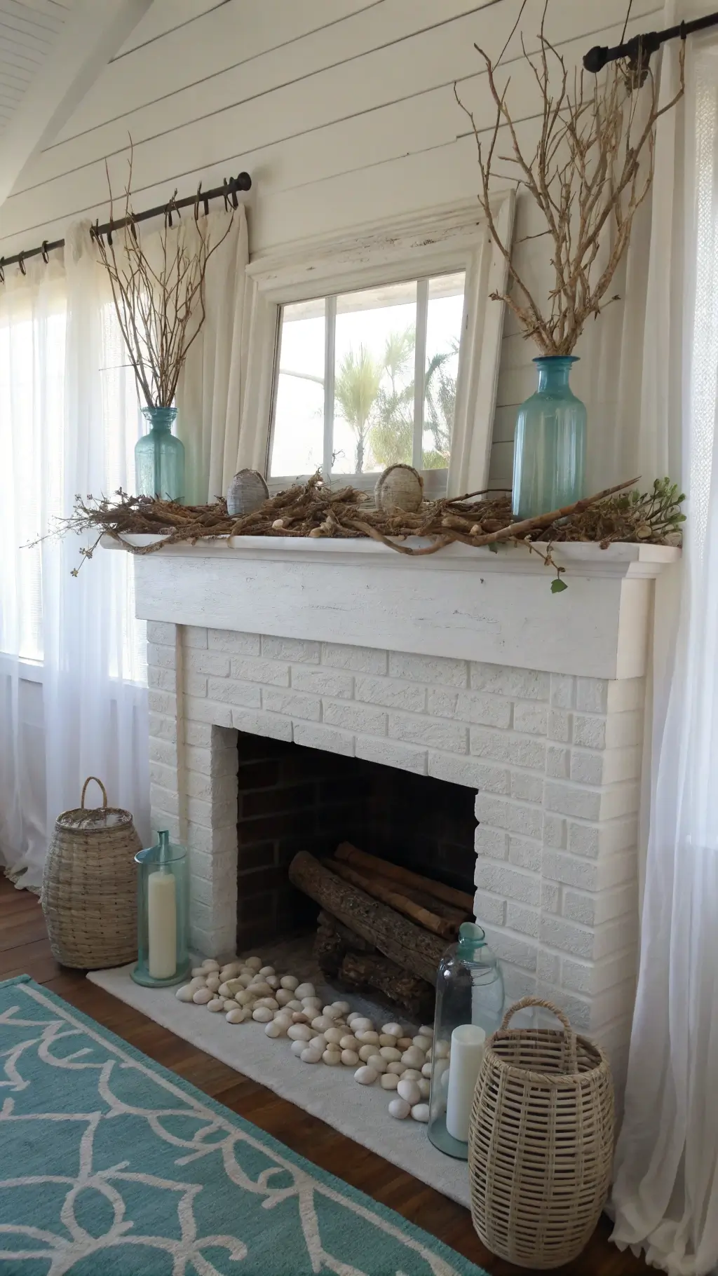 Coastal Easter fireplace vignette with driftwood garland, sea glass eggs, mercury glass vases, and mother of pearl frames in airy beach cottage setting.
