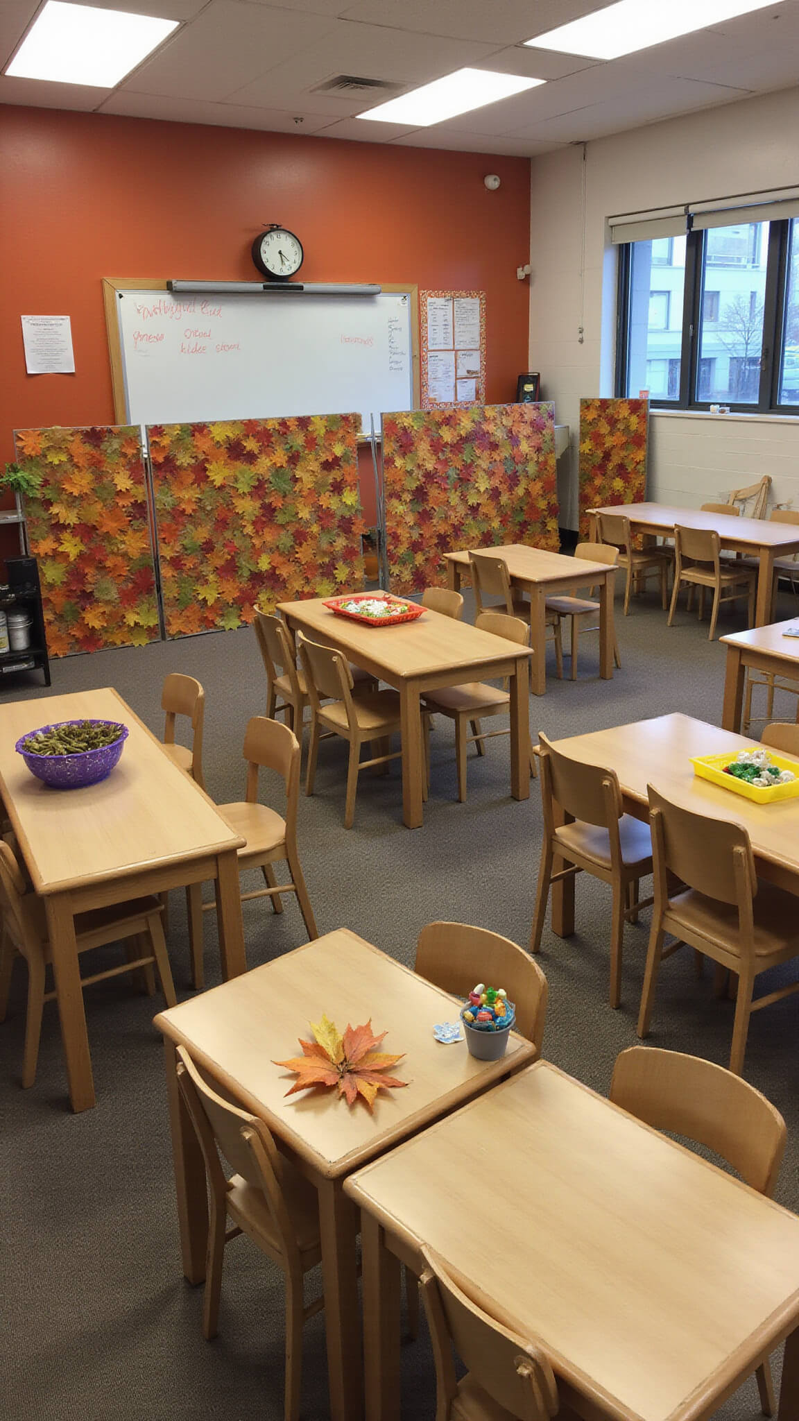 Open 25'x30' classroom during blue hour with autumn-themed leaf dividers, burnt orange accent walls, natural wood furniture, and harvest-themed student stations arranged in learning zones.