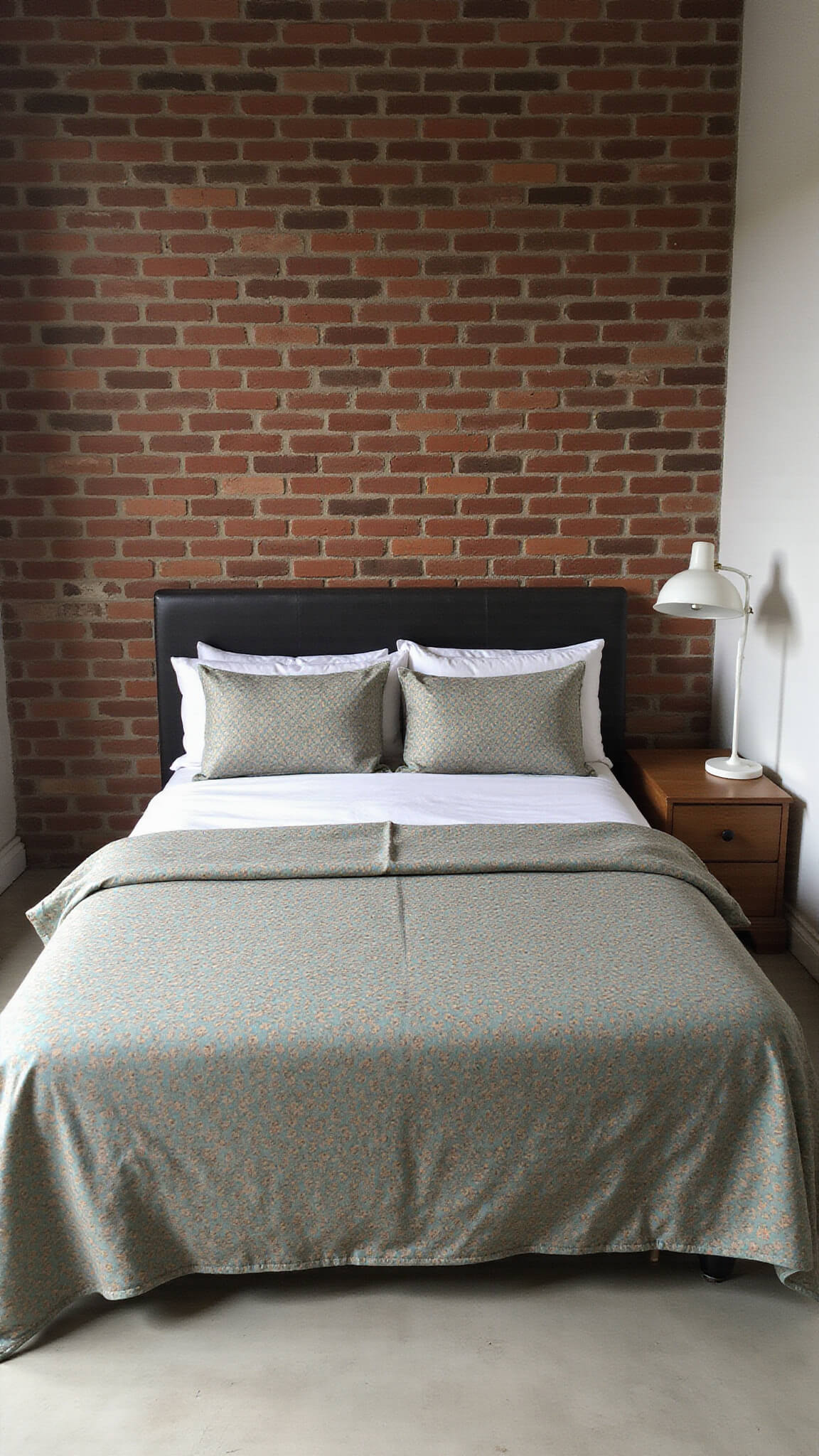 Cozy 11x13ft urban bedroom with exposed brick wall, queen bed in teal and copper vintage circle bedding, and mid-century modern lamp casting shadows; low-angle tilt-shift shot emphasizes textures and patterns.