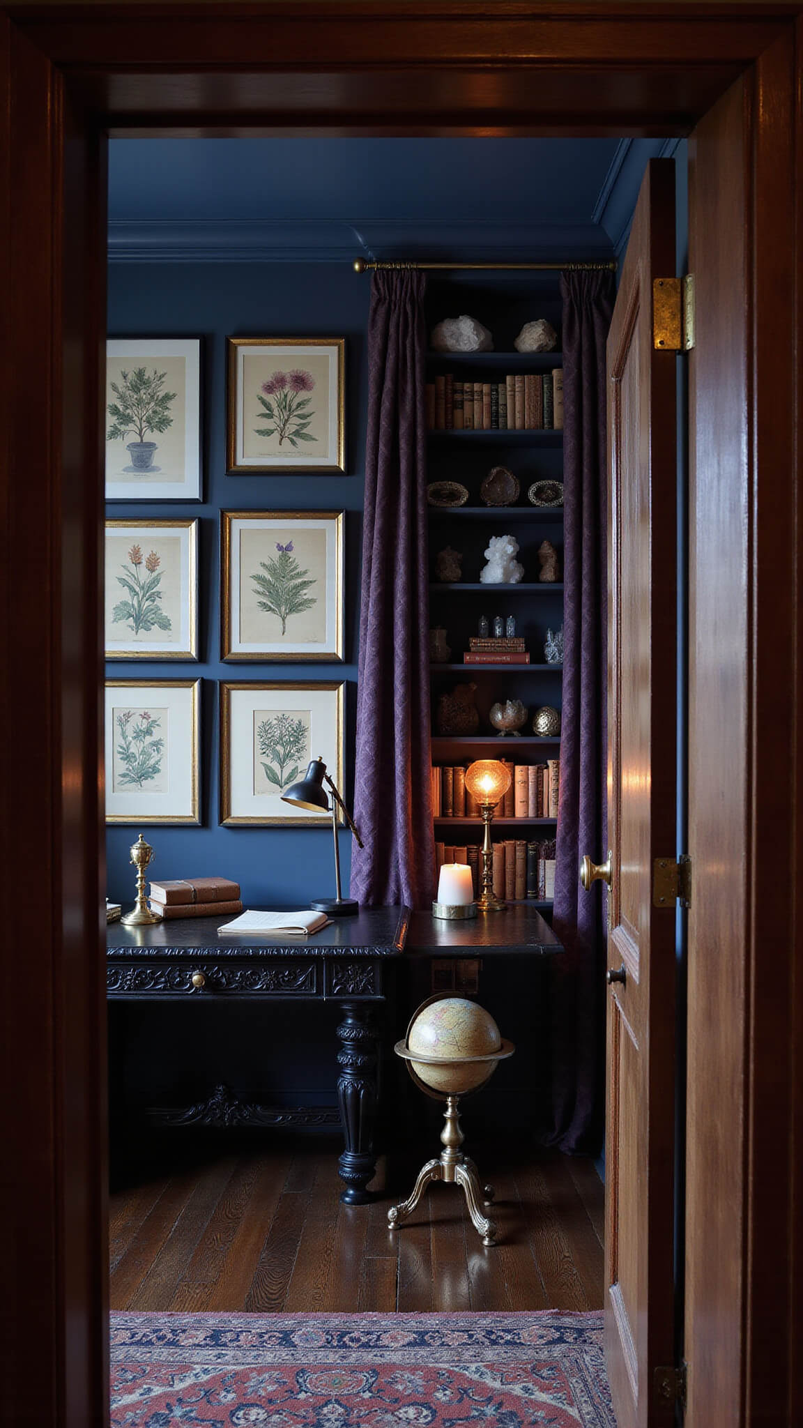 Moody dusk-lit home office with midnight blue walls, Victorian botanical prints, ebony desk with brass tools and journals, deep purple organza curtains, antique globe, bookshelves, salt lamps, and crystal specimens.