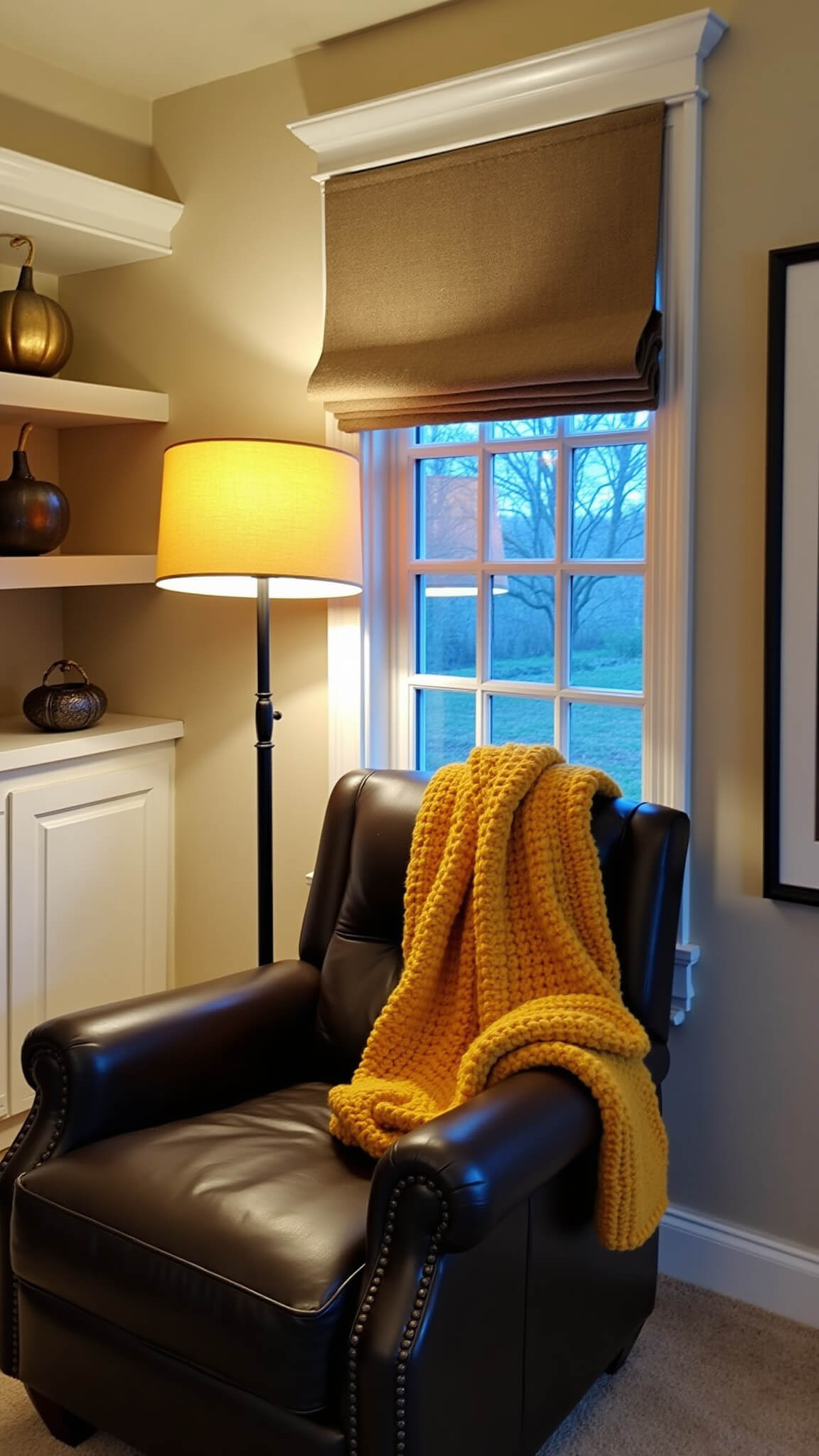Cozy bedroom reading nook with leather armchair, mustard knit throw, amber floor lamp, and floating shelves with metallic gourds.