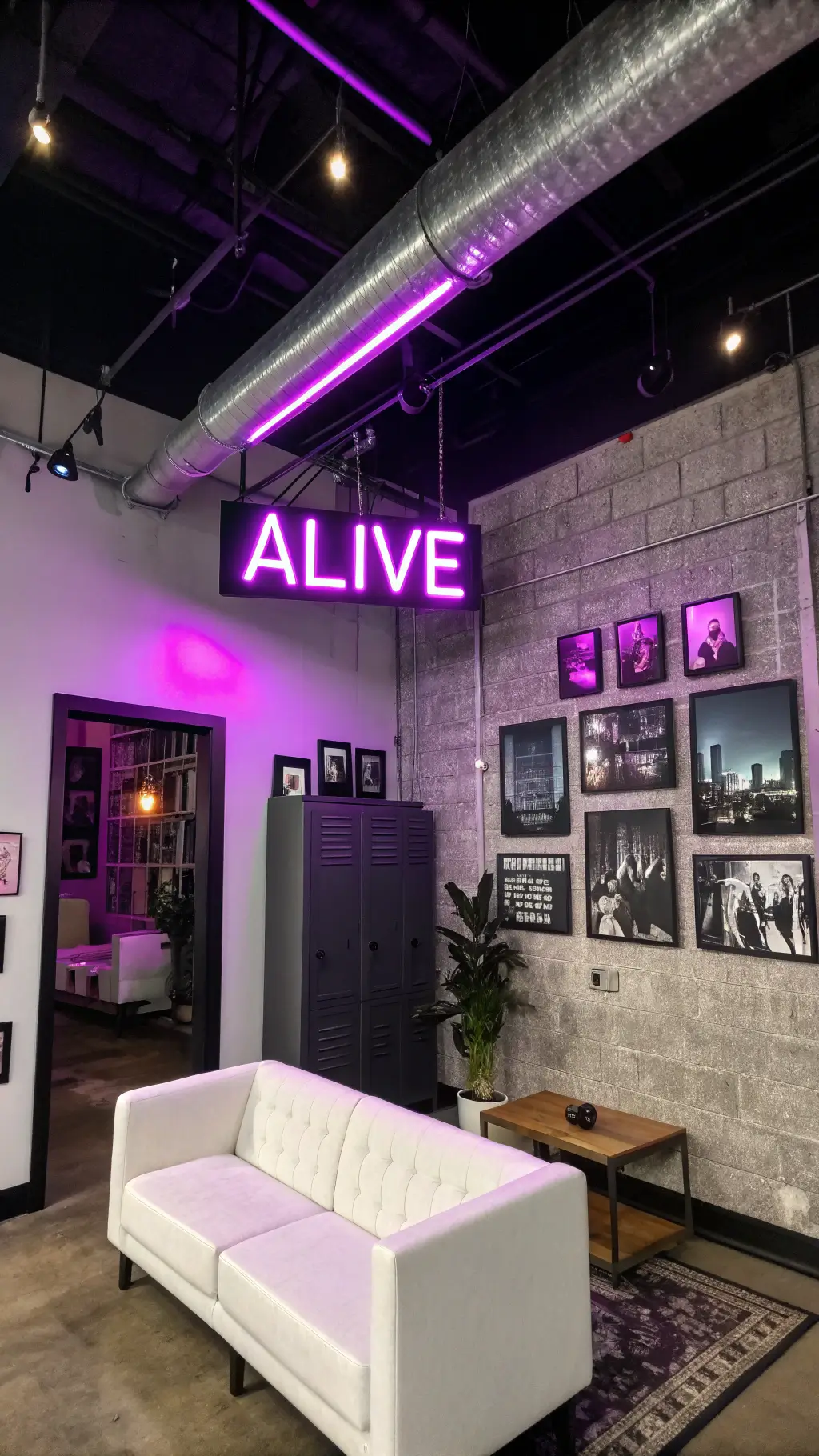Low-angle view of industrial-chic corner living space with 12ft concrete ceilings, black ductwork, neon purple 'ALIVE' sign, modular white seating, charcoal walls, vintage locker media cabinet, and black-and-white cityscape photos.