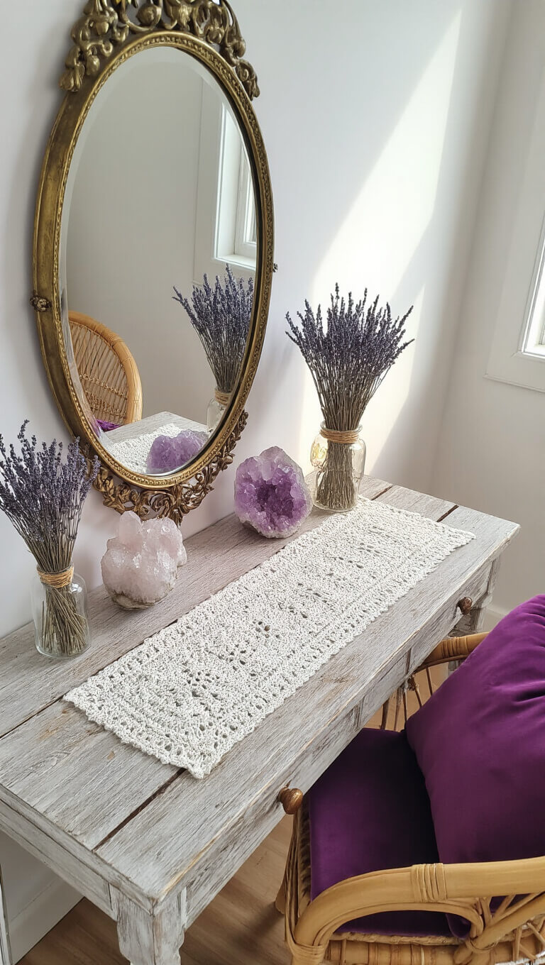 Vintage vanity with brass mirror, crystal clusters, dried lavender, and rattan chair with purple cushion on crochet-covered wood surface.